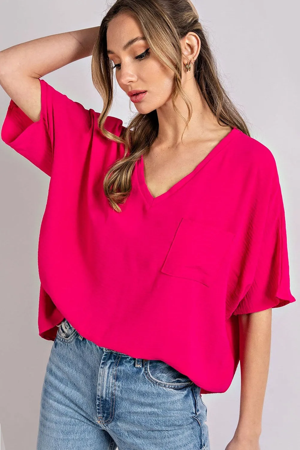 Woven top with V-neckline short sleeves and chest pocket