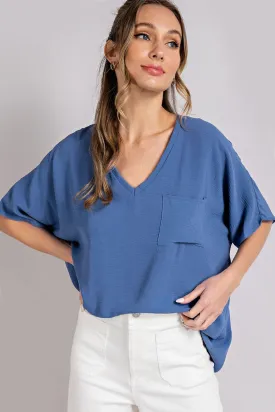 Woven top with V-neckline short sleeves and chest pocket