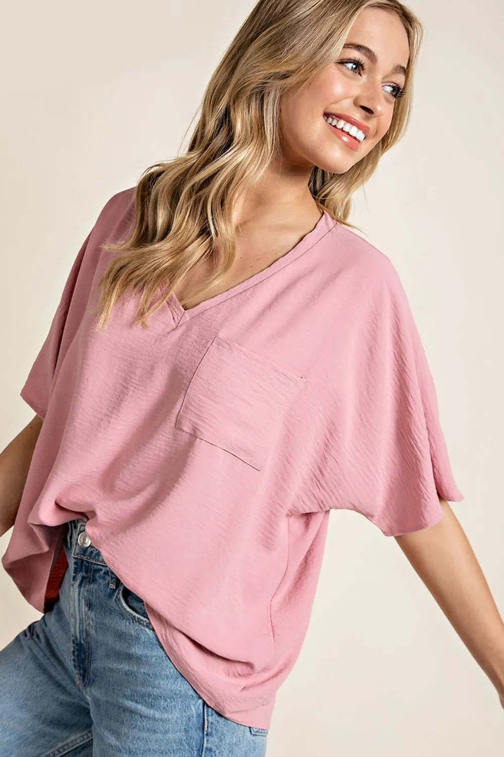 Woven top with V-neckline short sleeves and chest pocket